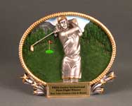 This is a image of a colorful oval resin gold trat featuring a female golfer in a swing
