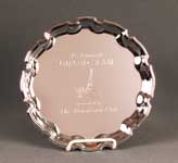 This is a image of a round fashioned edge chrome plated tray engraved with a golf graphic and text