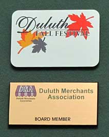 this is a image of two mimaki color imprinted badges