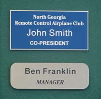 Image of two engraved plastic name badges