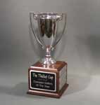 This is a image of a silver colored loving cup on a cube base set up as a perpetual award
