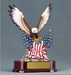 Image of a painted color eagle with crossed american flage set on a oval red base
