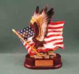 Image of a full color eagle holding an american flag as in flight set on a oval dark red base