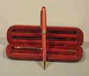 This is a image of a pen and pencil with a redwood box