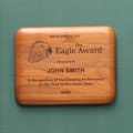 This is a image of a laser engraved walnut plaque with an elipitical edge and when selected will take the visitor to the plaques home page.